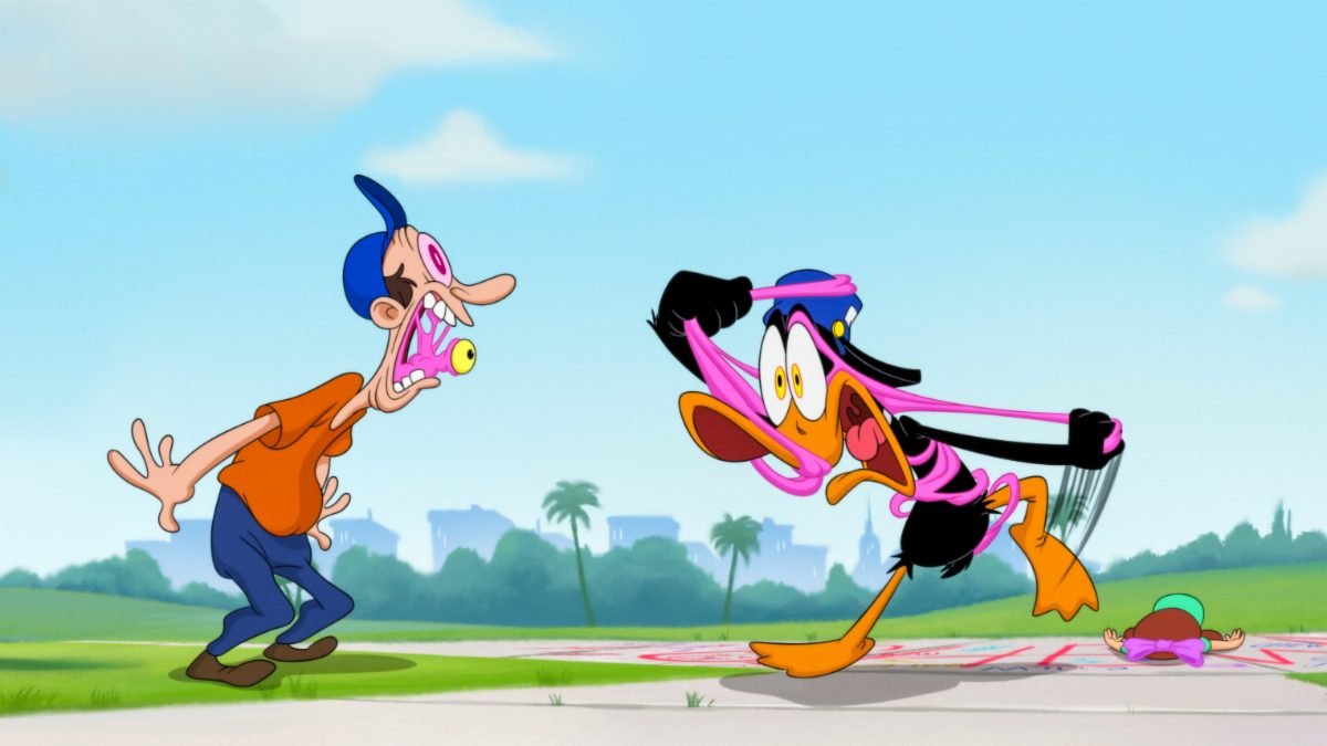 Daffy Duck (Eric Bauza) screams and struggles with his eyes bugging out while tangled up in pink bubblegum while a person with pink bubblegum with an eye on it sticks out of his mouth to watch, in the film, “The Day the Earth Blew Up” (2024).