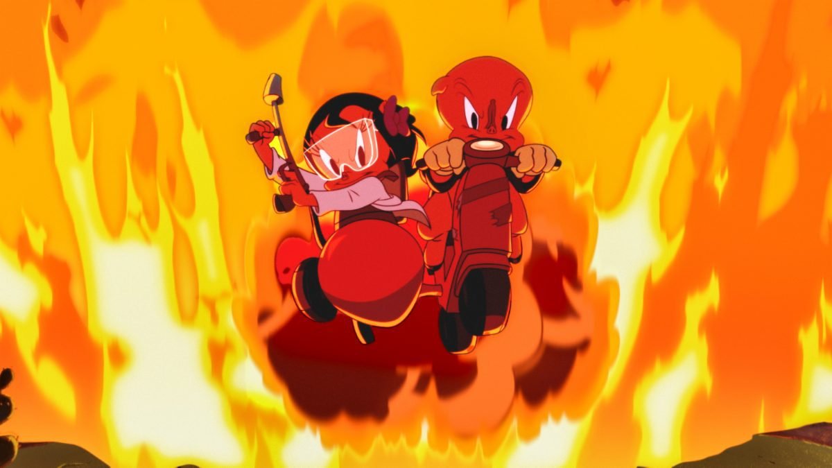 Porky Pig (Eric Bauza), with a clothespin on his nose, drives a motorcycle with Petunia Pig (Candi Milo) in a sidecar, wielding a blowtorch, both surrounded by flames, in the film, “The Day the Earth Blew Up” (2024).