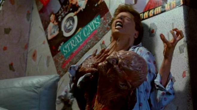Freddy Krueger's head bursts out of Jesse's stomach in A Nightmare on Elm Street 2